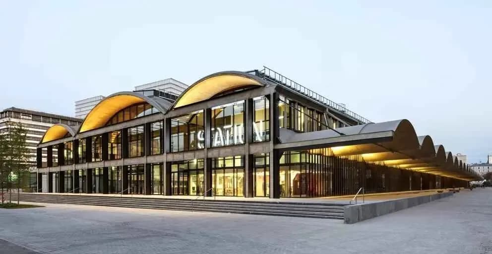 Station F in Paris, with its curved roofs and illuminated glass facade